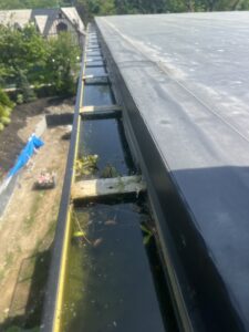 a wide view of a clogged gutter