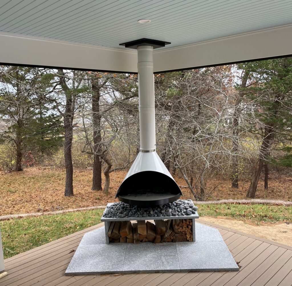 An outdoor fireplace on a porch